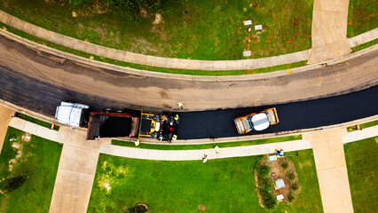 Overhead view of road getting a new asphalt surface