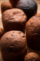 Freshly Baked Big and Small Panettone on Wooden Surface - closeup