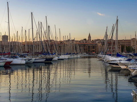 Amazing landscape  of  Vieux-Port of Marseille with nautical vessels and yachts, behind buildings of old city . Yellow sunset !