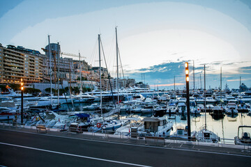 Port Hercule with motorboats and large Motor Yachts  and Monte Carelo buildings in left direction