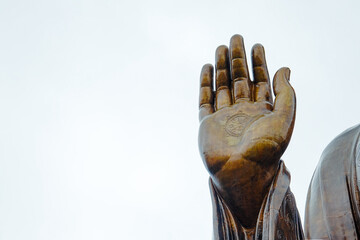 Big bronze hand of the Buddha statue with white background