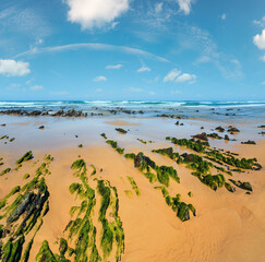 Rock formations on sandy beach (Algarve, Costa Vicentina, Portugal).