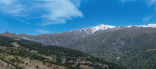 Summer mountain landscape with snow on peak (Sierra Nevada National Park, near Granada, Spain). 