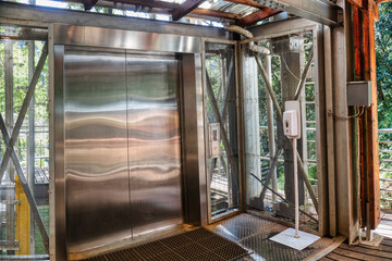 elevator outdoors in the nature liftin travelers into a gorge creek , tourist attraction, mountains...