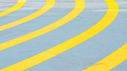 Yellow and white curved lines painted on the asphalt.