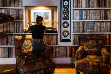 Vinyl record enthusiast in a cozy music room