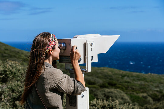 Tourist using coastal viewing scope