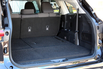 Modern wagon car open trunk. Car boot is open. Clean, open empty trunk in the black car SUV. 