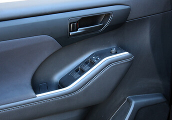 Premium SUV inside door handle. SUV door control panel. Window lifters control. Armrest with...