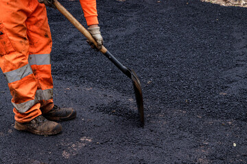 Paving Perfection: Worker Repairing Pavement