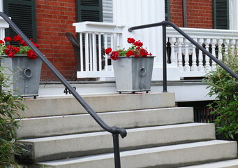 Potted Red Geraniums Atop Housefront Steps