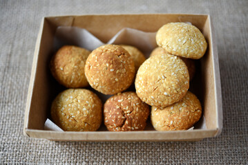 Sweet sesame cookies in a box on burlap. Cookies in a box.