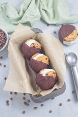 Mint chocolate chips ice cream and chocolate chips cookies sandwiches, vertical top view