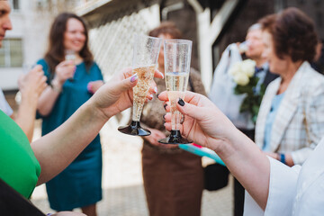 a group of people are toasting with champagne glasses