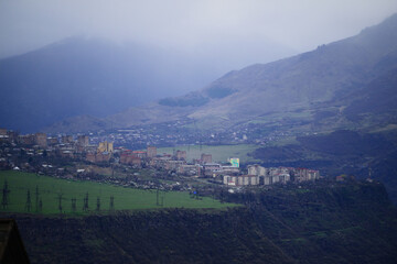 Fototapeta premium Alaverdi town and Sanahin village in foggy weather, Armenia