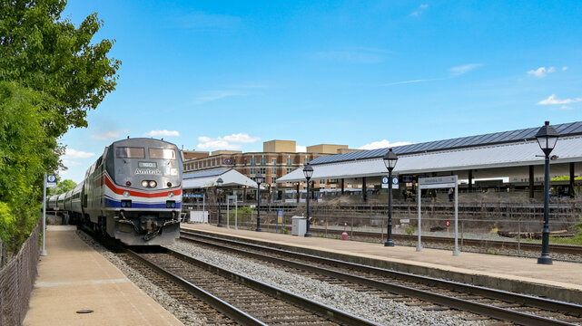 Alexandria, Washington DC, USA - 1 May 2024: Amtrak train arriving at the town's railway station.