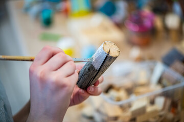 cute teen girl at a master class making a craft from wood, exhibition of crafts, crafts fair,...