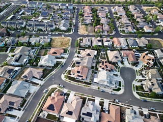 aerial view of a middle class brand new residential houses neighborhood in a city  suburbs. suburbia, 