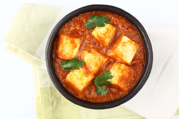 Paneer curry recipe made using cottage cheese, served in a bowl. selective focus Delhi, Rajasthan India.  Indian veg curry also called Paneer butter masala