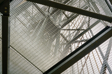 New modern tall metal construction observation tower with steel grid floors, bottom up view - Powered by Adobe