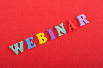 WEBINAR word on red background composed from colorful abc alphabet block wooden letters, copy space...