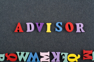 ADVISOR word on black board background composed from colorful abc alphabet block wooden letters,...
