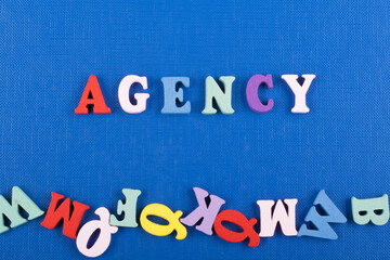 AGENCY word on blue background composed from colorful abc alphabet block wooden letters, copy space...