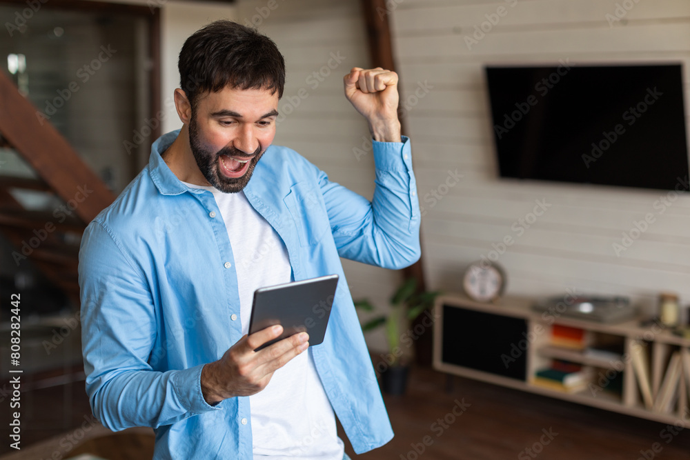 Aufkleber A man wearing a blue jacket is seen holding a tablet device in his hands. The man appears focused on the tablet screen as he interacts with the device.