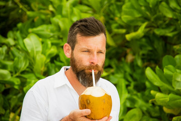 handsome man portrait and lush tropical greenery