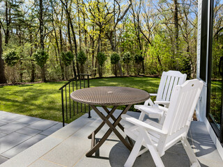 Table for two - Table and chairs on a sunny patio in a suburban garden on a bright and sunny Spring...
