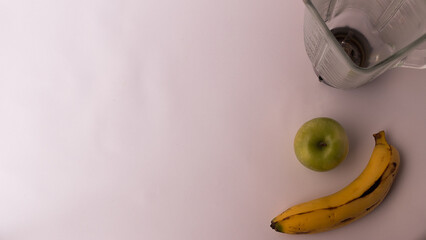 blender next to banana and green apple on white background, nutrition, green juice