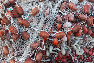 Large pile of fishing nets with floats.
