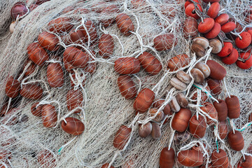 Large pile of fishing nets with floats.