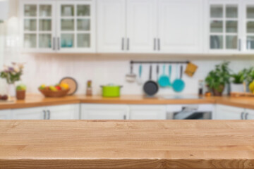 Kitchen wood table top for product display with blurred modern interior. Wooden tabletop over...