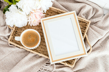 Bohemian style photo frame mockup with coffee cup, and bouquet of flowers on plaid. Top view © photoguns