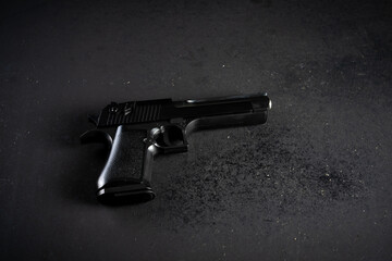Gun on black table, criminal concept