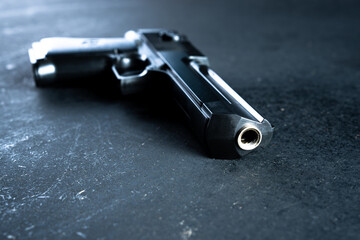 Gun on black table, criminal concept