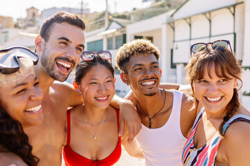 Happy diverse group of friends enjoying summer holiday at beach. Vacation lifestyle concept