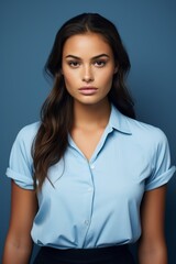 Obraz premium Confident young professional woman in blue blouse