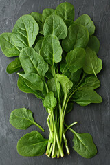 bunch of green spinach on wooden table 