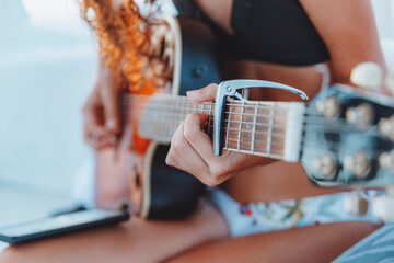 Woman Playing Guitar on the Beach
