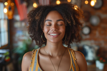 Young African American woman smiling with eyes closed in a cozy cafe