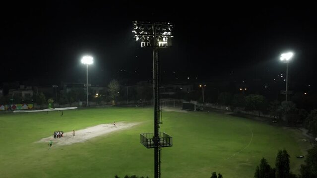 Slow and smooth orbit of flood light of cricket stadium flood light during match.