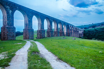 Aqueduct in mountains at blue hour, arcos del sitio in tepotzotlan state of mexico