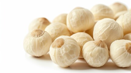 Close-up of a group of cashew nuts, emphasizing their textured, wrinkled skin and rich color, isolated on a stark white background