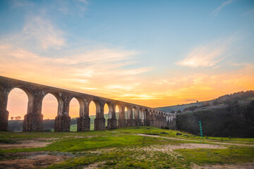 Aqueduct between mountains at sunrise with cloudy sky in arcos del sitio in tepotzotlan state of...