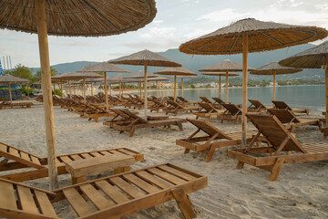 wooden sun beds and parasols on Alikanas beach