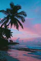 Pink and blue sunset at summer beach with palm trees silhouette, tropical vacation paradise scene