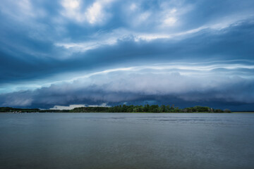 Two merging storm fronts by river