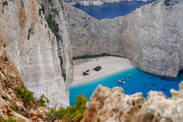 famous upper viewpoint of the Navagio Beach shipwreck surroundedby limestone cliffs